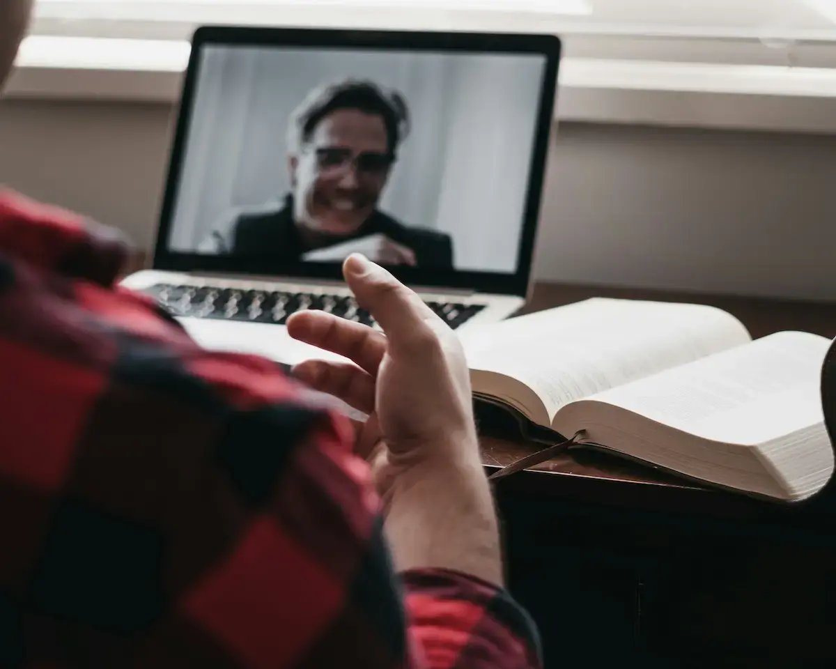 A person speaking with a therapist over video